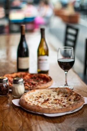 Pizza and wine on the table at Fat Tony's